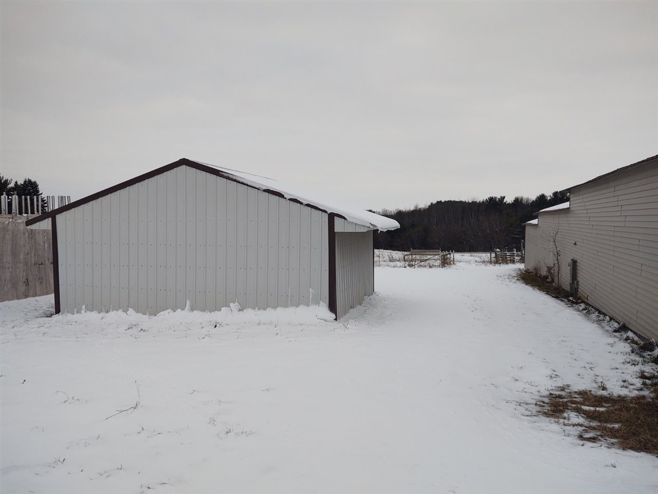 16253 Best Road Davis, IL 61019 - Photo 20 of 25 a view of white house with a snow in the background