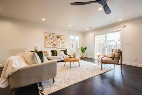 a living room with furniture and wooden floor