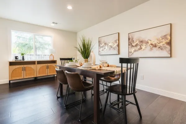 a dining room with furniture and window