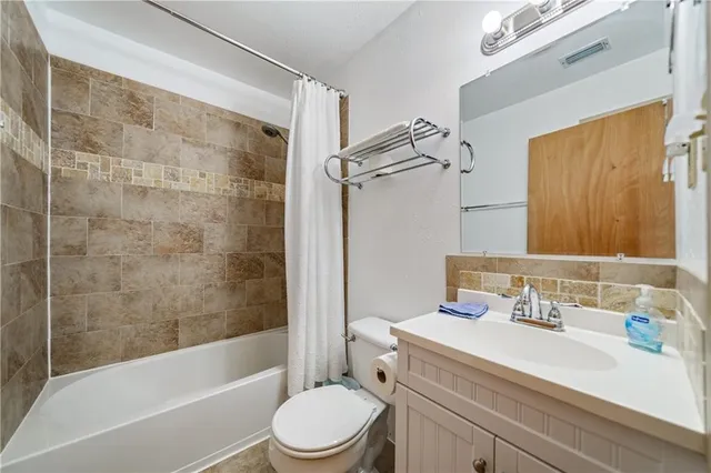 a bathroom with a sink a toilet and a bathtub