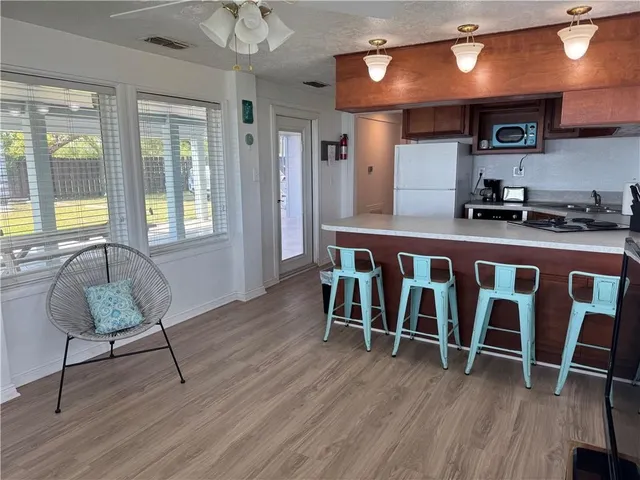 a living room with wooden floor and furniture