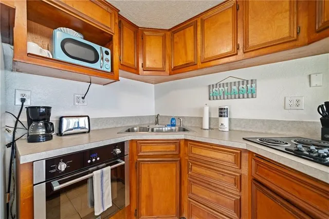 a kitchen with stainless steel appliances granite countertop a stove and cabinets