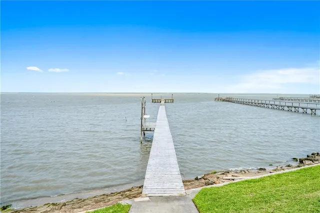 a view of a lake with couches in the back