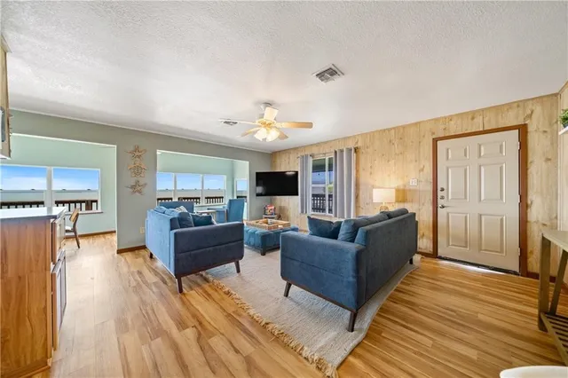 a living room with furniture and a wooden floor