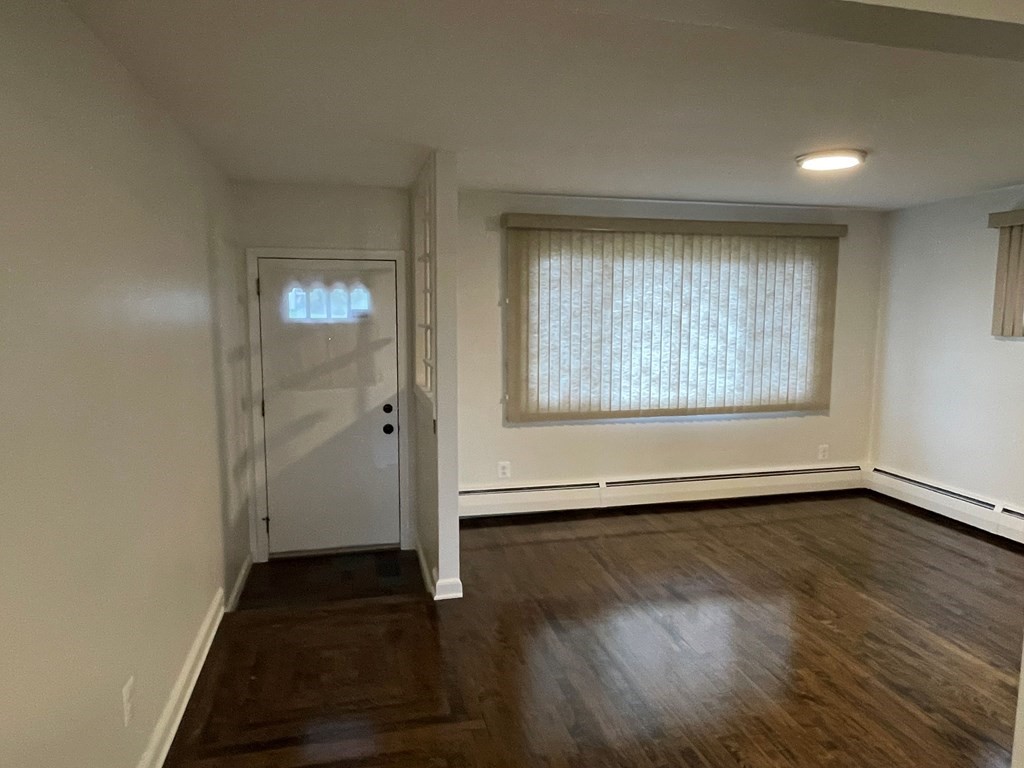 40 Dillon Street Worcester, MA 01604 - Photo 11 of 23 an empty room with wooden floor and windows