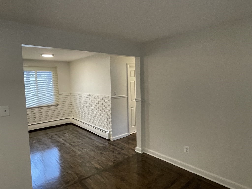 40 Dillon Street Worcester, MA 01604 - Photo 12 of 23 an empty room with wooden floor and windows