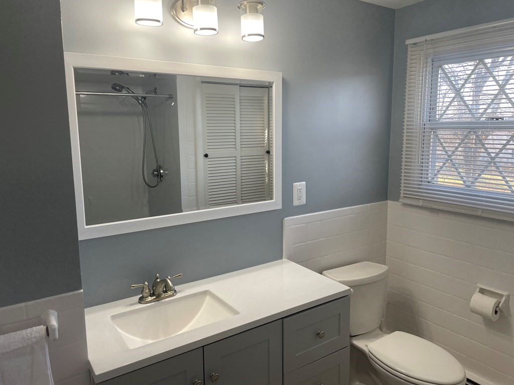 40 Dillon Street Worcester, MA 01604 - Photo 16 of 23 a bathroom with a sink toilet vanity and tub