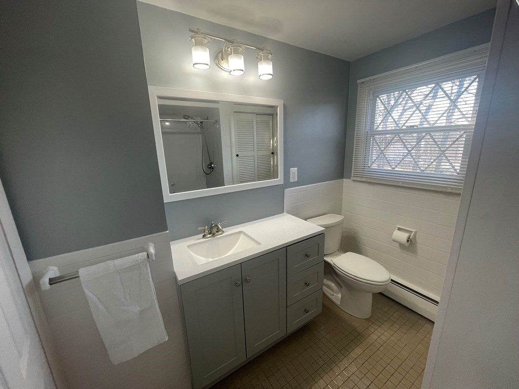 40 Dillon Street Worcester, MA 01604 - Photo 17 of 23 a bathroom with a toilet sink and mirror