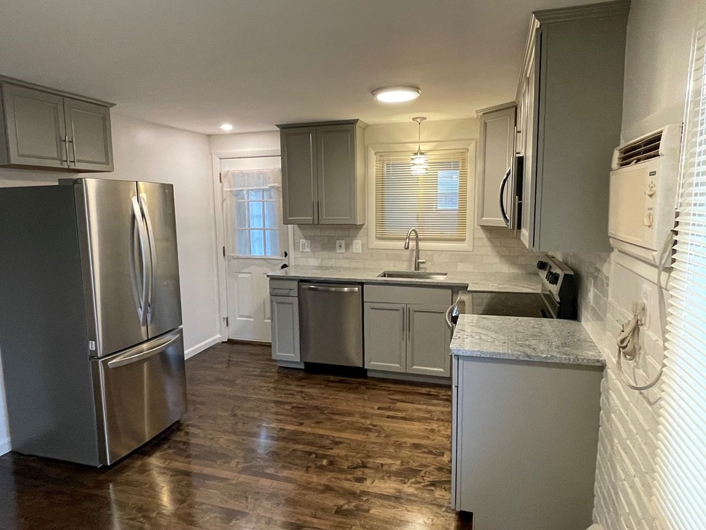 40 Dillon Street Worcester, MA 01604 - Photo 7 of 23 a kitchen with stainless steel appliances granite countertop a refrigerator a sink and a stove