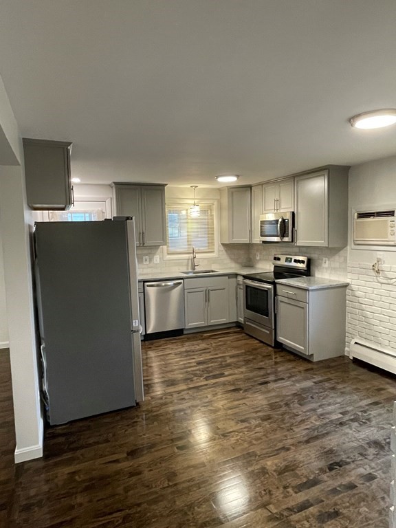 40 Dillon Street Worcester, MA 01604 - Photo 8 of 23 a kitchen with granite countertop a refrigerator and a stove top oven