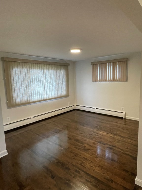 40 Dillon Street Worcester, MA 01604 - Photo 10 of 23 an empty room with wooden floor and windows