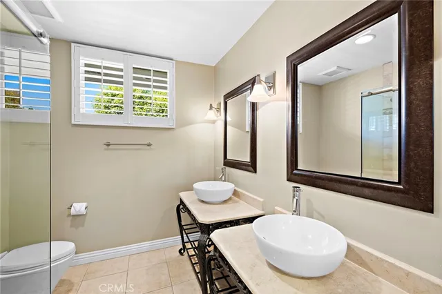 a bathroom with a shower a toilet and a sink