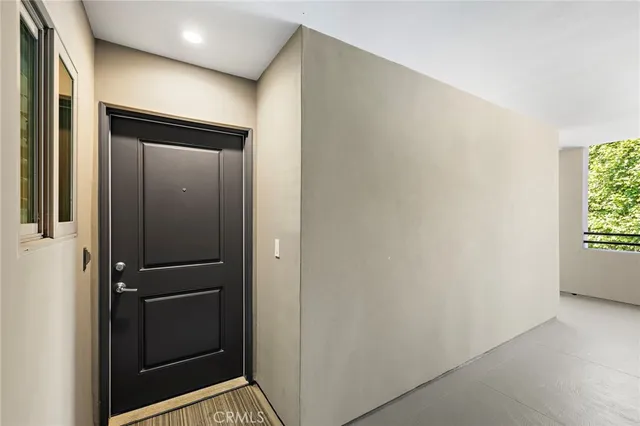a view of a hallway with wooden floor and a living room