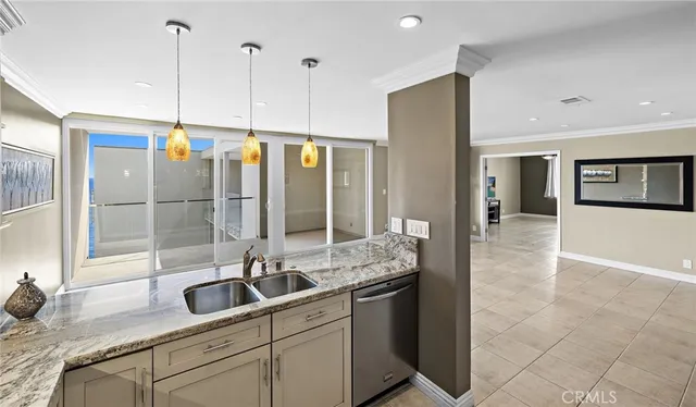 a kitchen with stainless steel appliances granite countertop a sink and a refrigerator