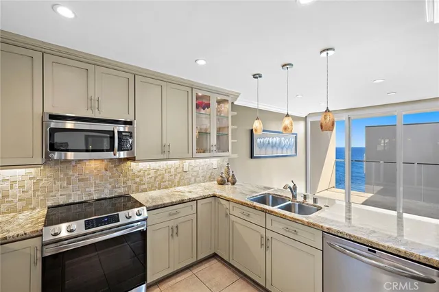 a kitchen with a sink and stainless steel appliances