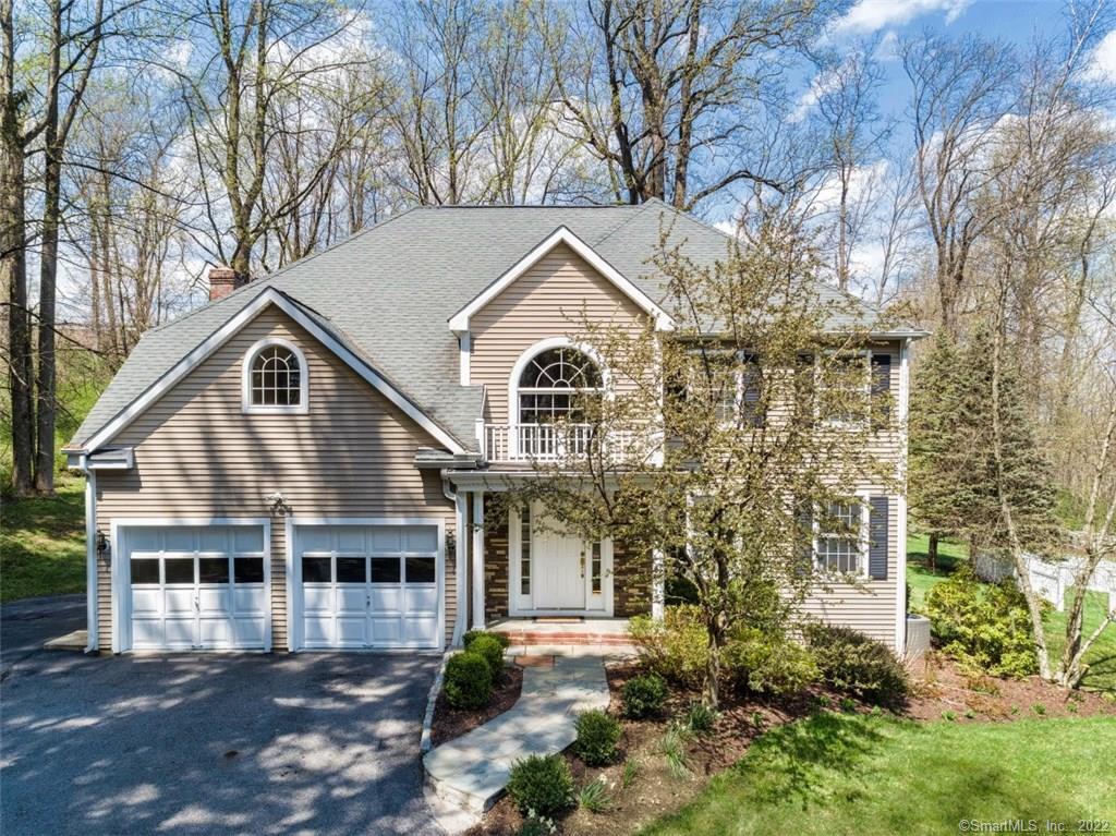 11 Barnum Place Ridgefield, CT 06877 - Photo 1 of 1 a front view of a house with a yard and fountain