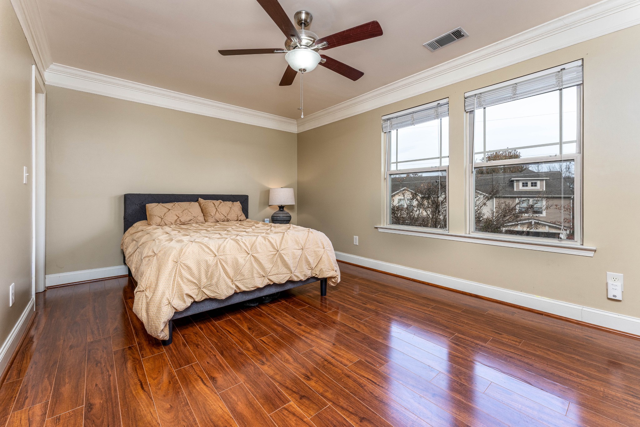 735 Tulip Grove Road, Unit 210 Hermitage, TN 37076 - Photo 13 of 32 a bedroom with a large bed and a large window with wooden floor