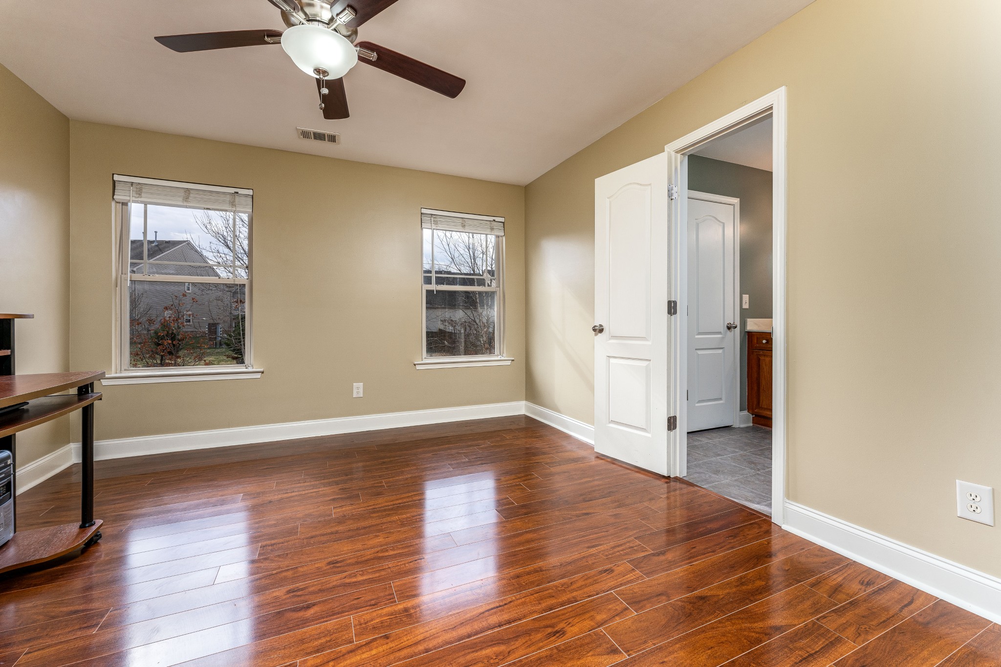 735 Tulip Grove Road, Unit 210 Hermitage, TN 37076 - Photo 19 of 32 an empty room with wooden floor and windows