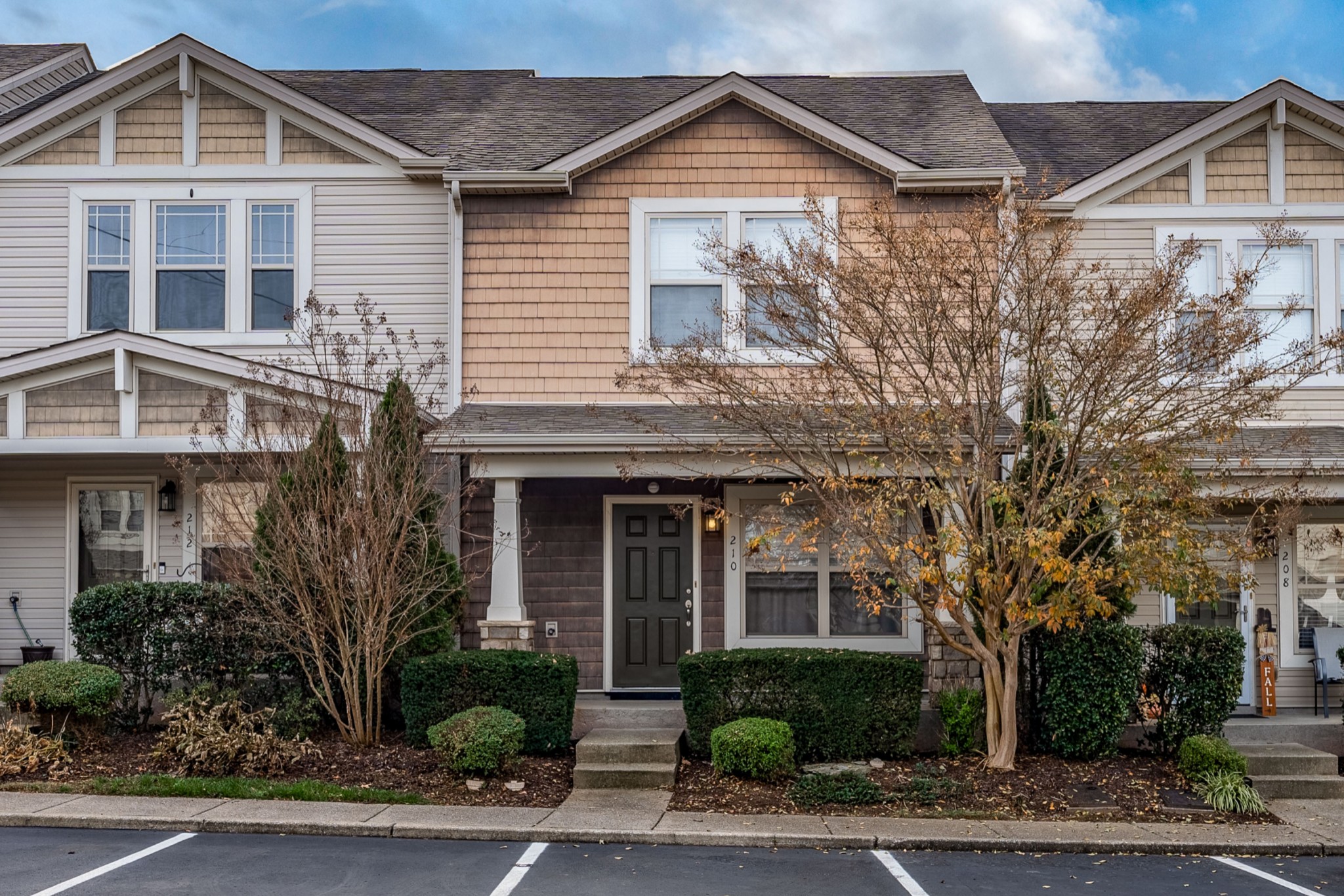 735 Tulip Grove Road, Unit 210 Hermitage, TN 37076 - Photo 2 of 32 a front view of a house with a yard and potted plants