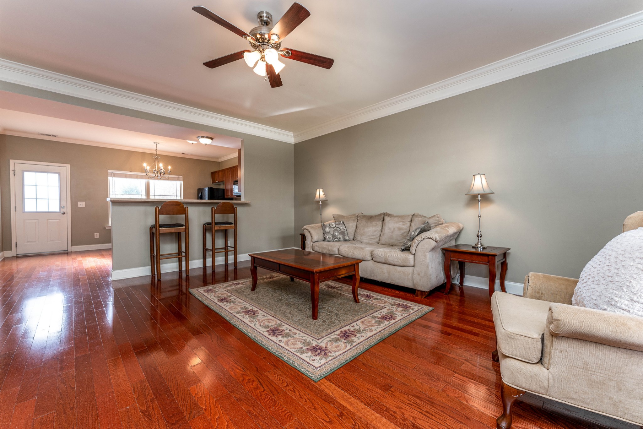 735 Tulip Grove Road, Unit 210 Hermitage, TN 37076 - Photo 4 of 32 a living room with furniture a wooden floor and a chandelier