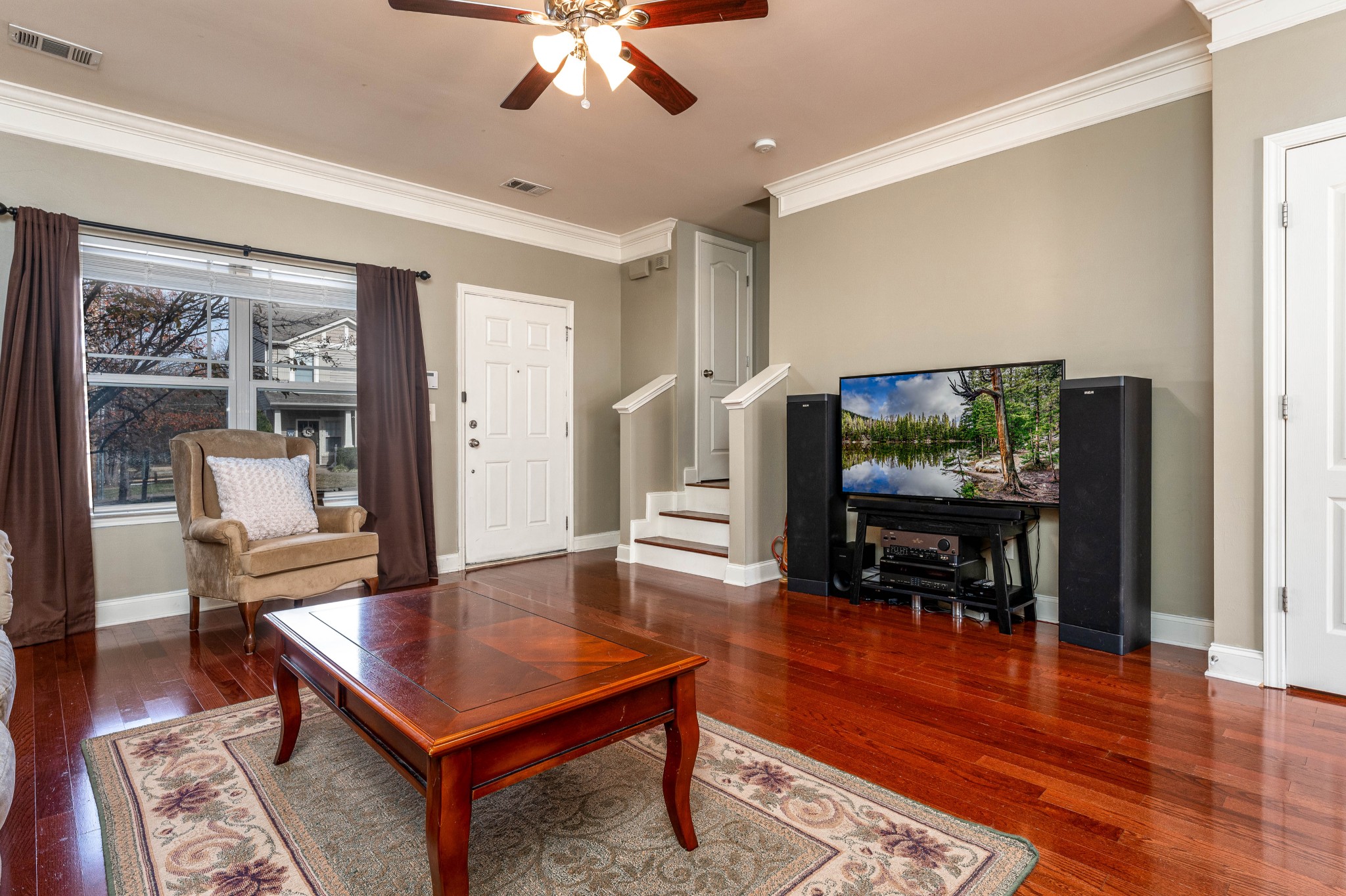 735 Tulip Grove Road, Unit 210 Hermitage, TN 37076 - Photo 6 of 32 a living room with furniture and a flat screen tv