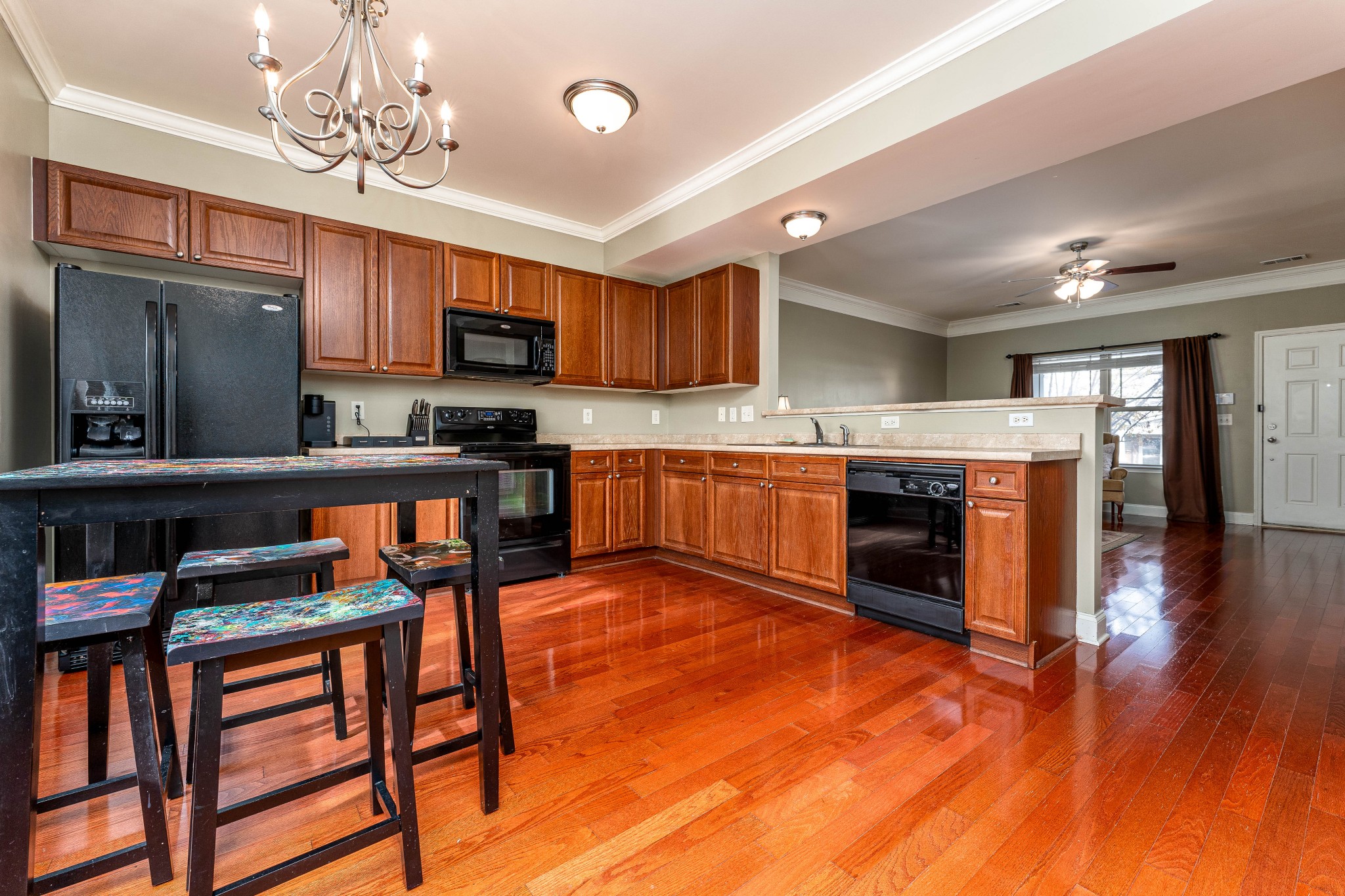 735 Tulip Grove Road, Unit 210 Hermitage, TN 37076 - Photo 9 of 32 a large kitchen with stainless steel appliances granite countertop a stove top oven a sink dishwasher and white cabinets with wooden floor