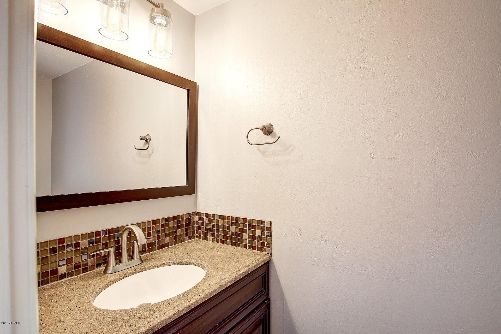 6909 East Osborn Road, Unit F Scottsdale, AZ 85251 - Photo 13 of 55 a bathroom with a sink and a mirror