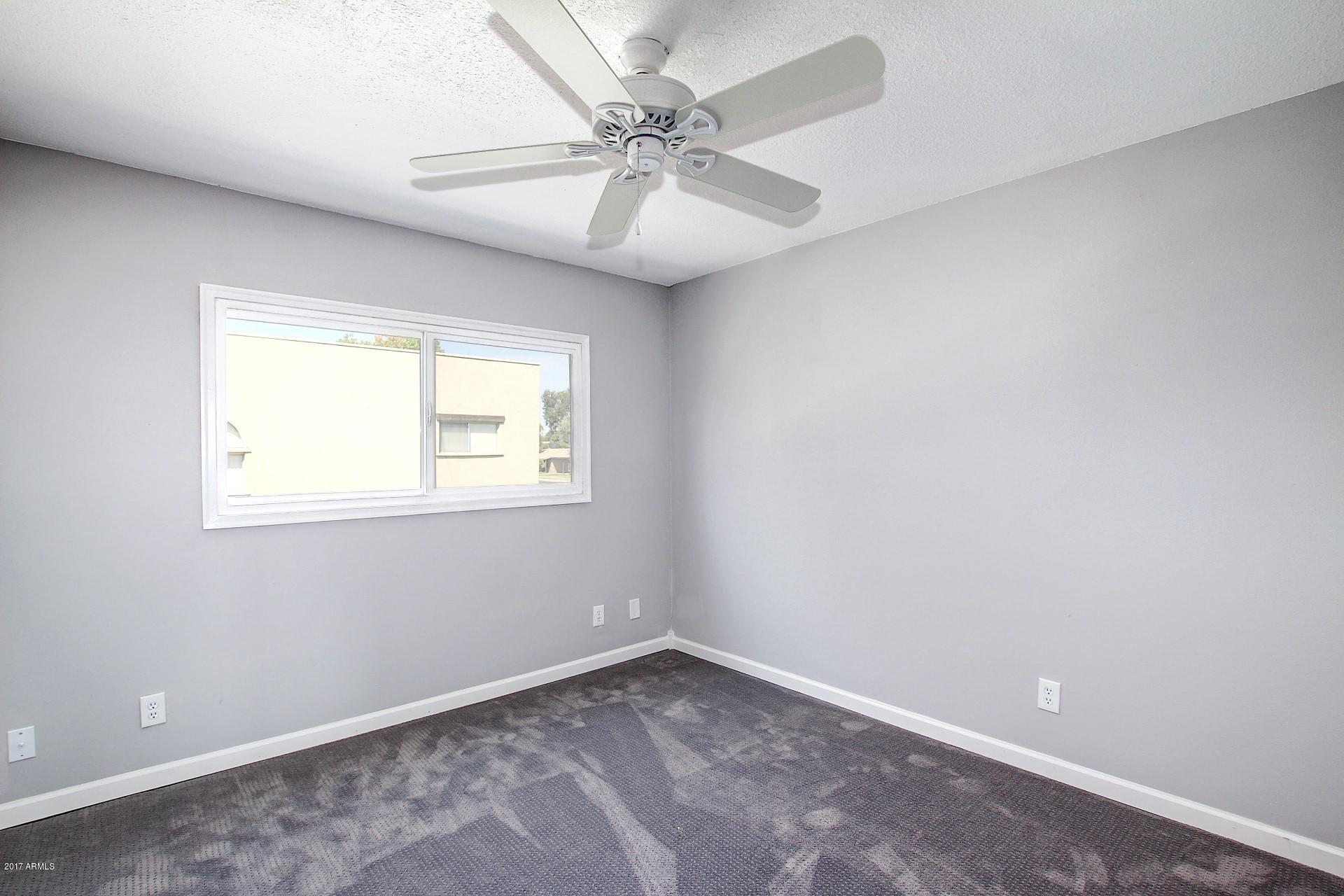 6909 East Osborn Road, Unit F Scottsdale, AZ 85251 - Photo 15 of 55 an empty room with a window and a fan
