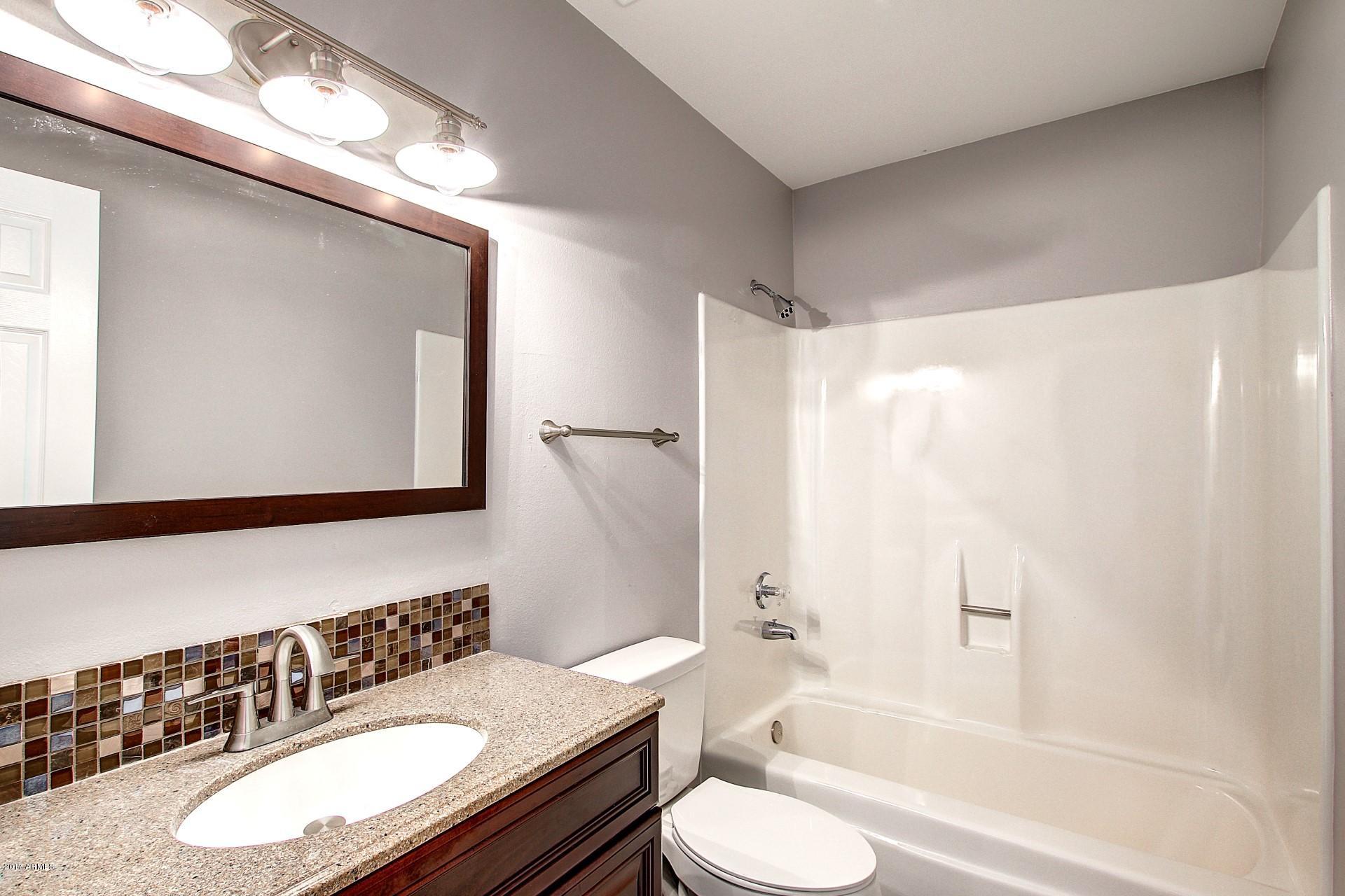 6909 East Osborn Road, Unit F Scottsdale, AZ 85251 - Photo 17 of 55 a bathroom with a sink a toilet and shower