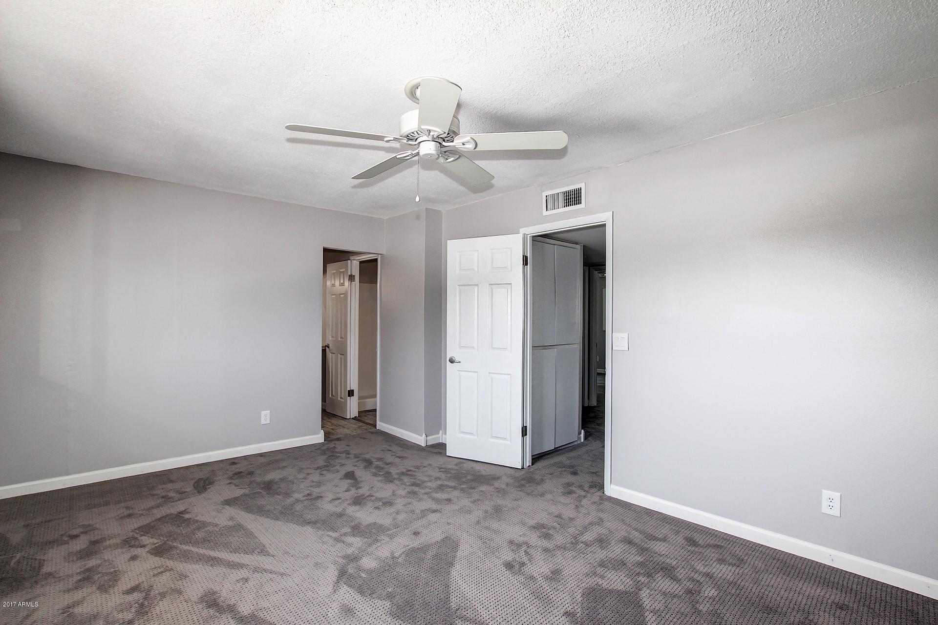 6909 East Osborn Road, Unit F Scottsdale, AZ 85251 - Photo 18 of 55 an empty room with closet and a ceiling fan