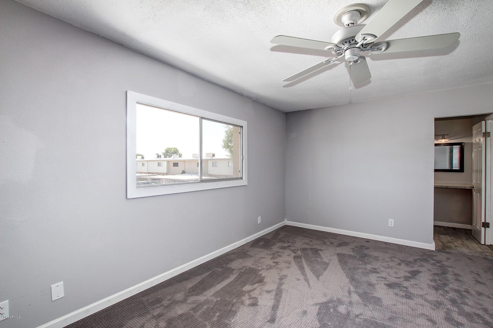 6909 East Osborn Road, Unit F Scottsdale, AZ 85251 - Photo 19 of 55 wooden floor in an empty room with a window