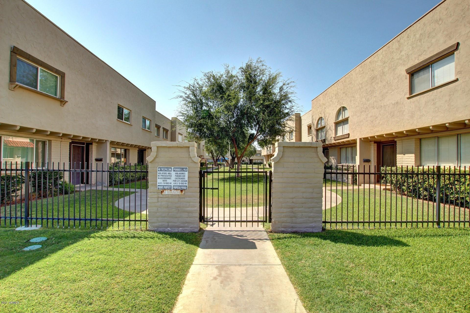 6909 East Osborn Road, Unit F Scottsdale, AZ 85251 - Photo 2 of 55 a front view of a house with a garden and plants