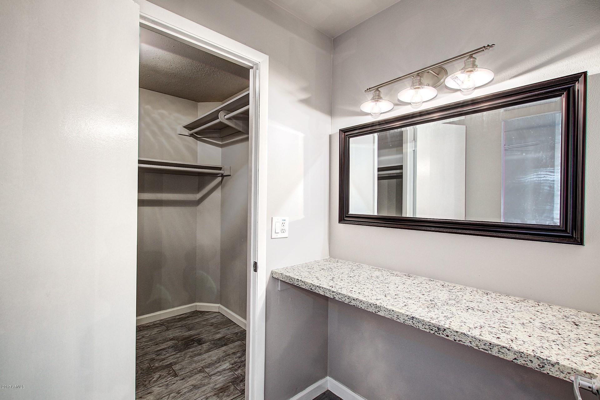 6909 East Osborn Road, Unit F Scottsdale, AZ 85251 - Photo 21 of 55 a bathroom with a granite countertop sink and a mirror