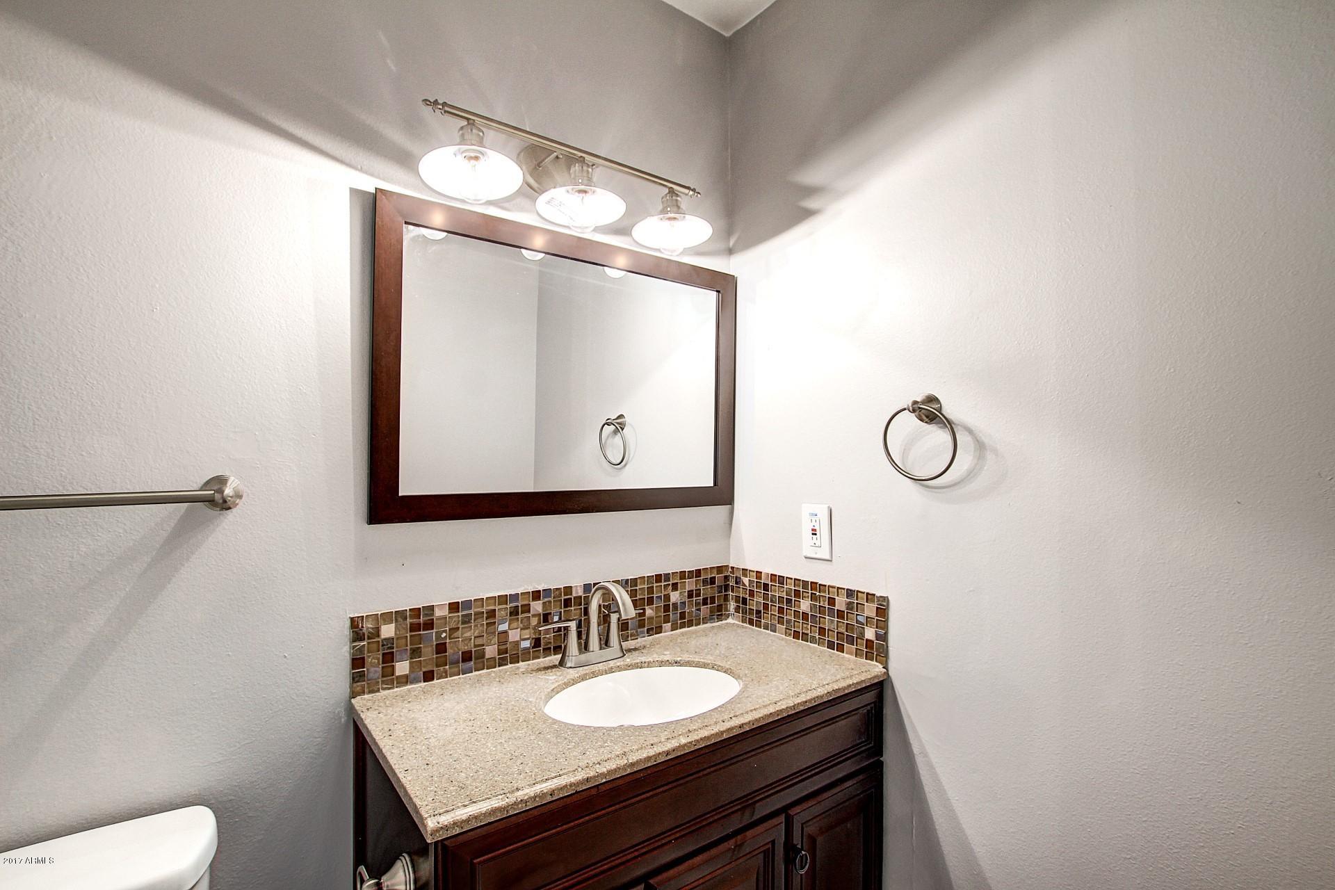 6909 East Osborn Road, Unit F Scottsdale, AZ 85251 - Photo 23 of 55 a bathroom with a sink and a mirror