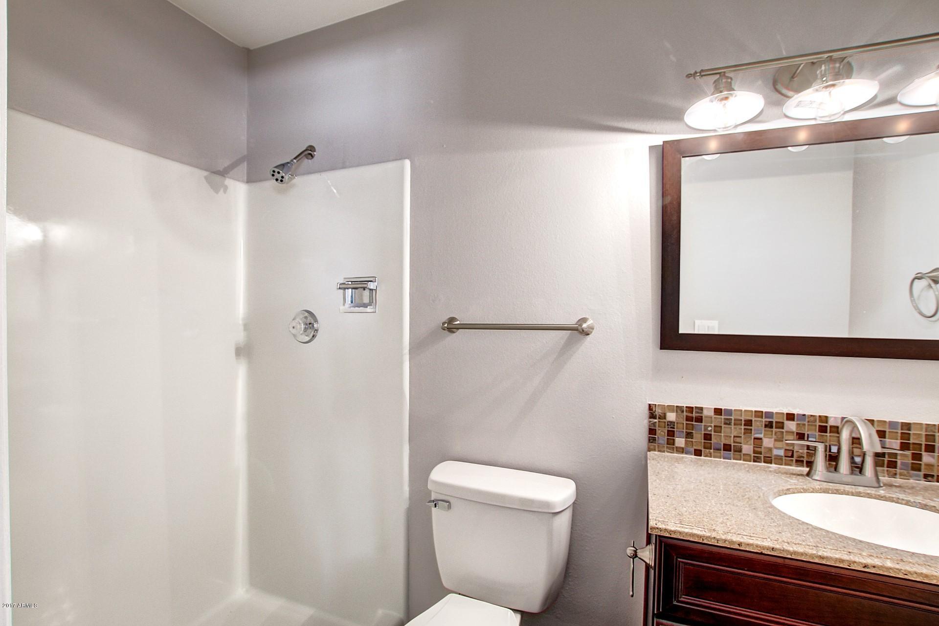 6909 East Osborn Road, Unit F Scottsdale, AZ 85251 - Photo 24 of 55 a bathroom with a sink a toilet and shower