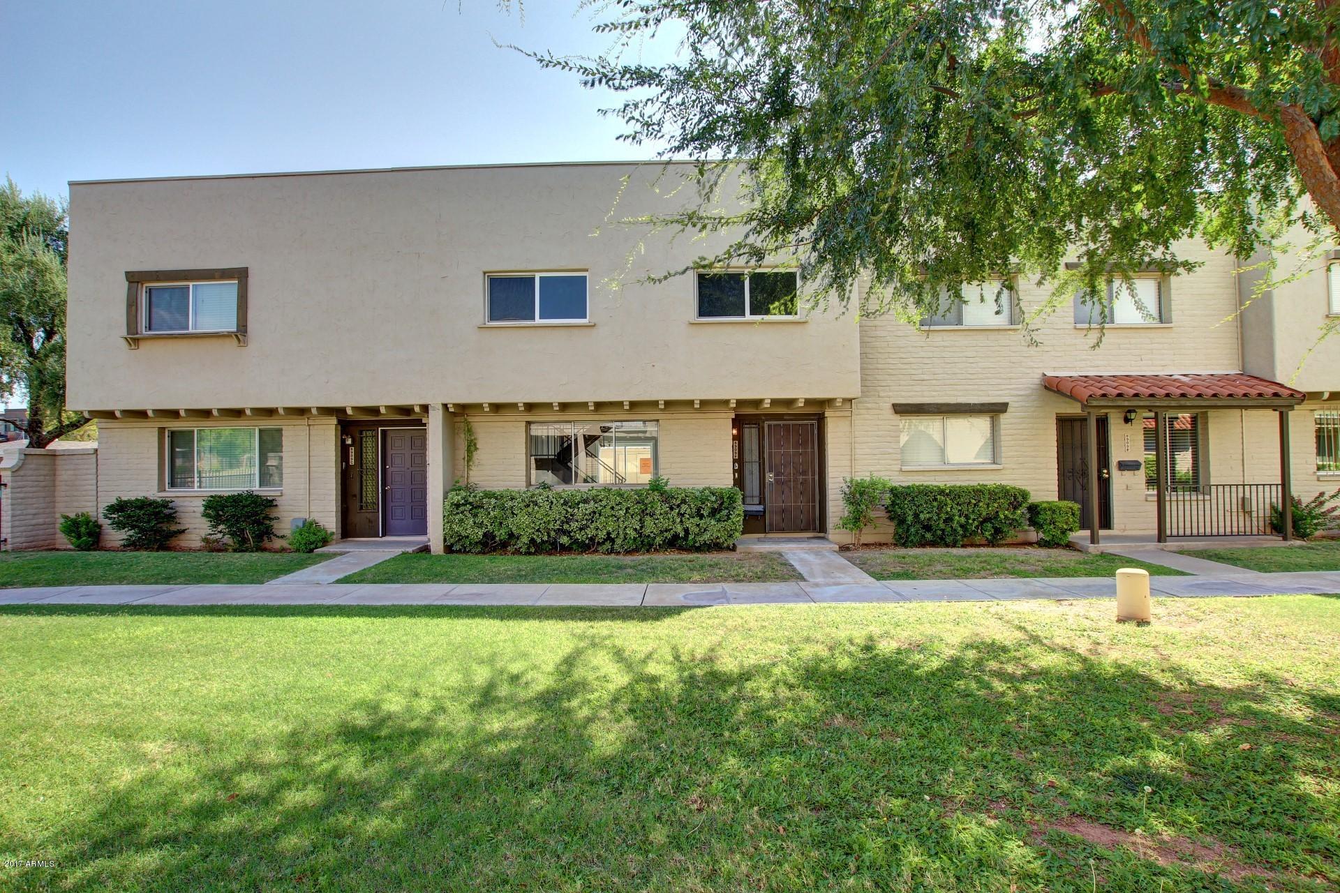 6909 East Osborn Road, Unit F Scottsdale, AZ 85251 - Photo 26 of 55 a front view of a house with a yard