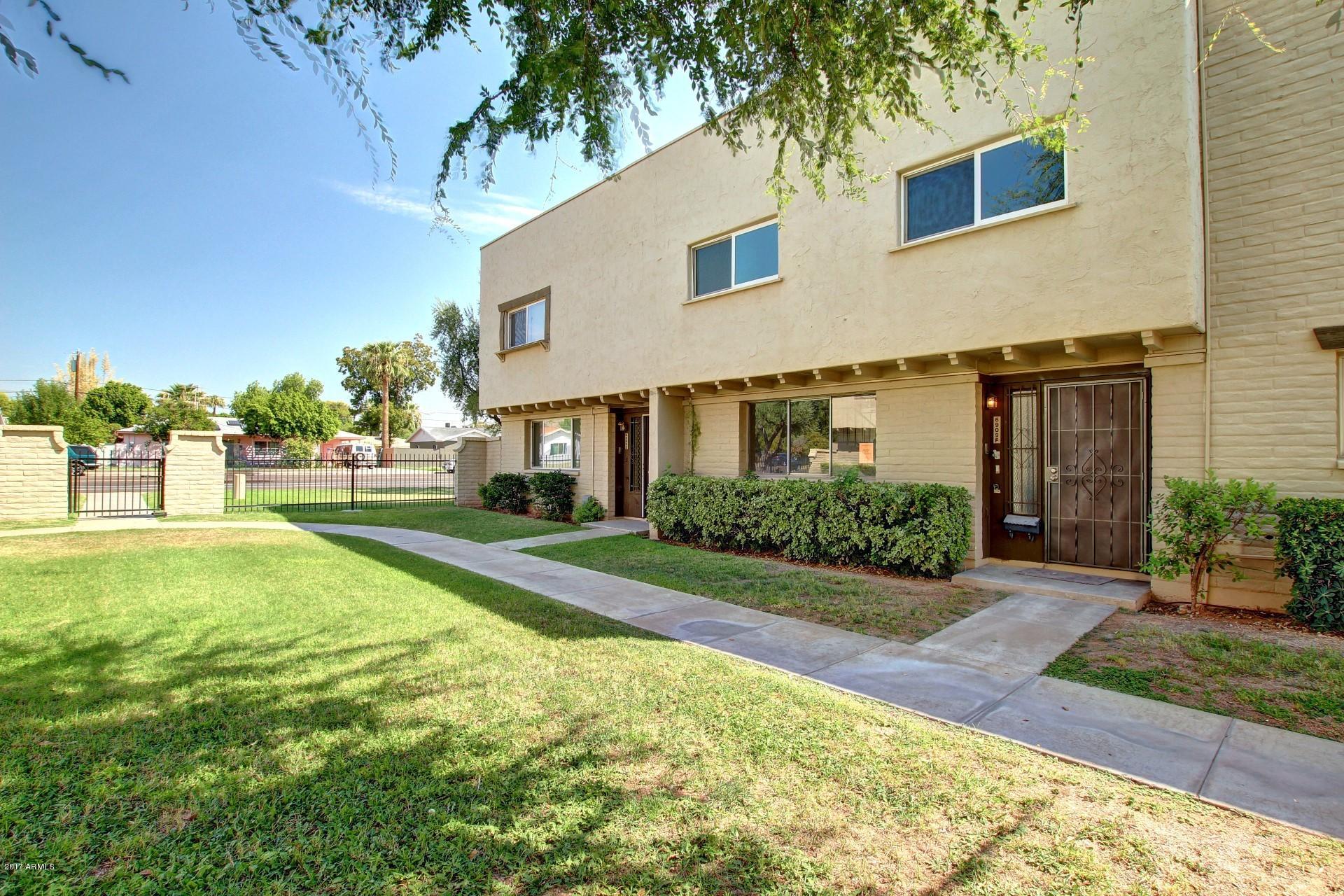 6909 East Osborn Road, Unit F Scottsdale, AZ 85251 - Photo 27 of 55 a front view of a house with yard and green space