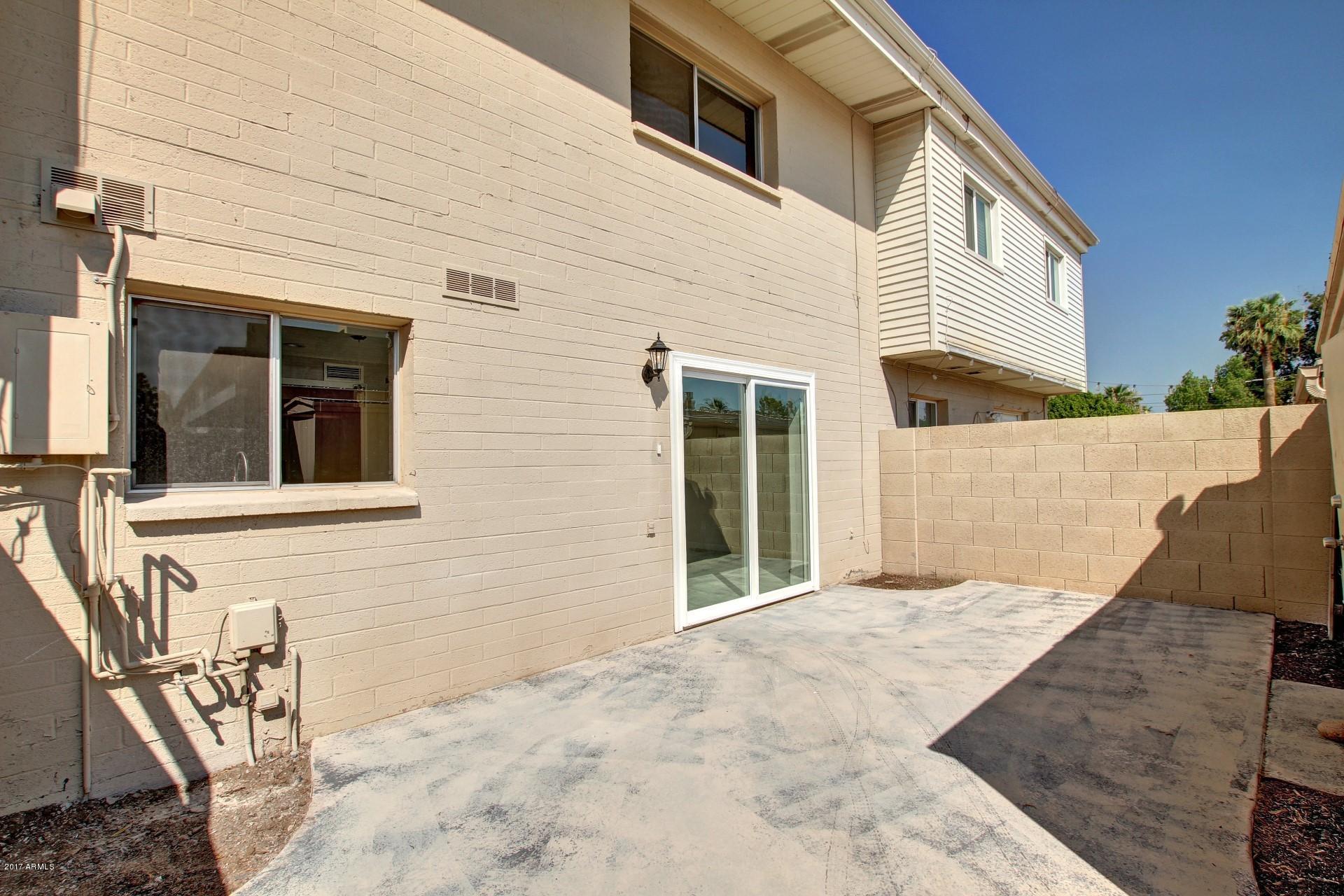 6909 East Osborn Road, Unit F Scottsdale, AZ 85251 - Photo 28 of 55 a view of a house with a wooden fence