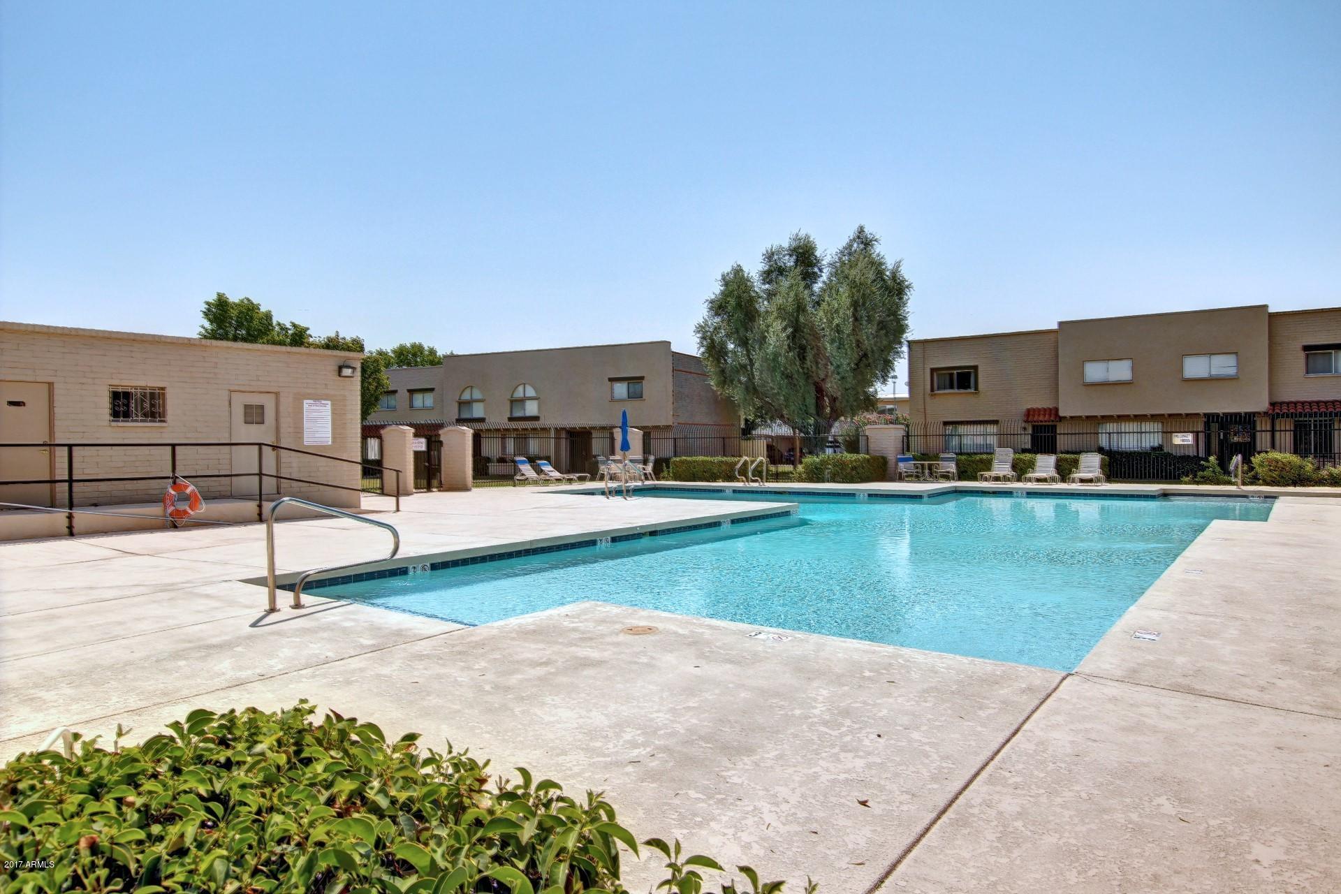 6909 East Osborn Road, Unit F Scottsdale, AZ 85251 - Photo 32 of 55 a swimming pool with outdoor seating and yard