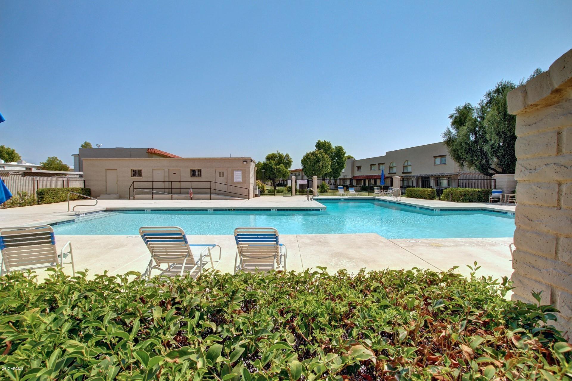6909 East Osborn Road, Unit F Scottsdale, AZ 85251 - Photo 33 of 55 a view of a swimming pool with lounge chair