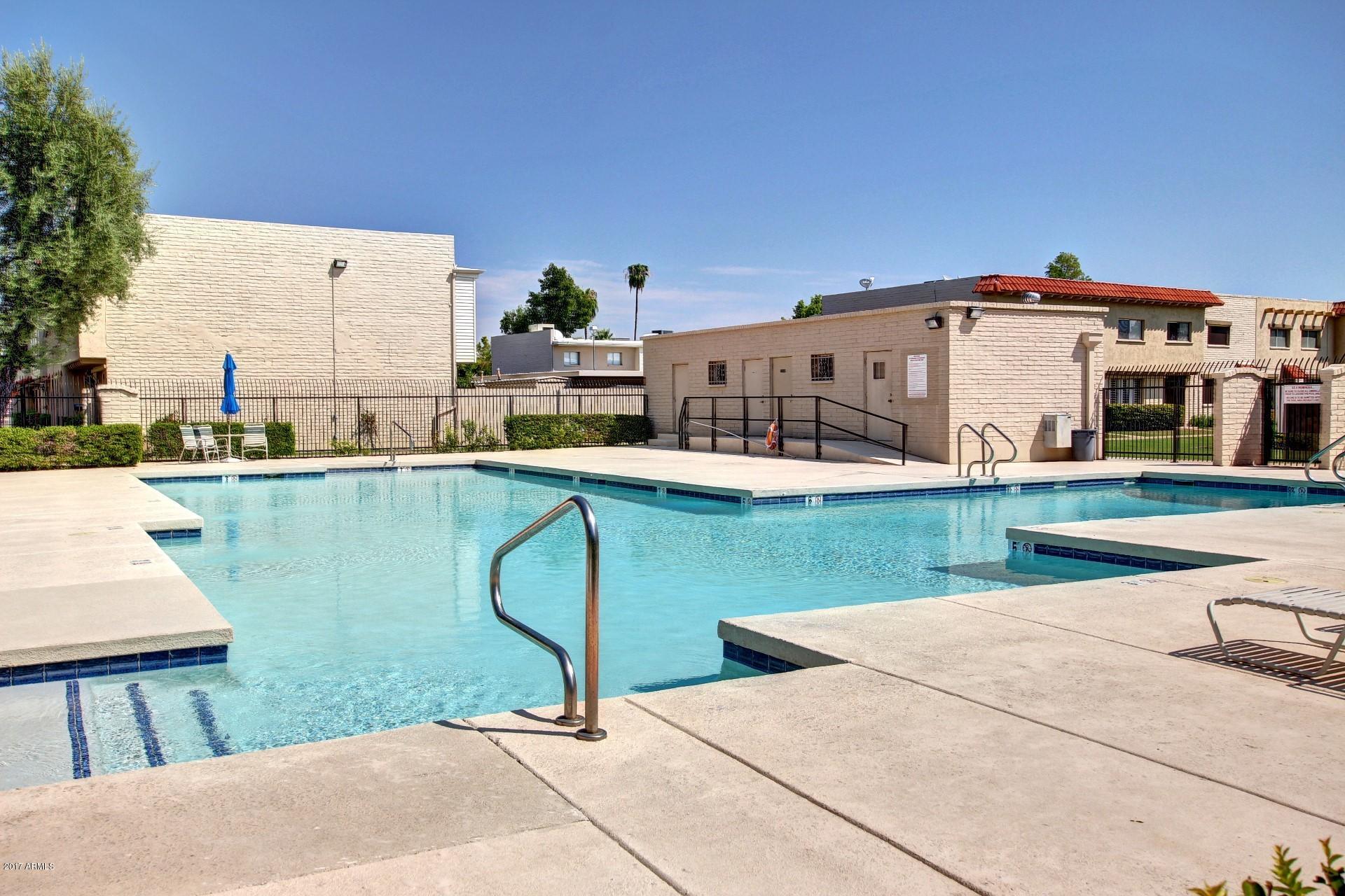6909 East Osborn Road, Unit F Scottsdale, AZ 85251 - Photo 34 of 55 a view of a lake with a house in the background