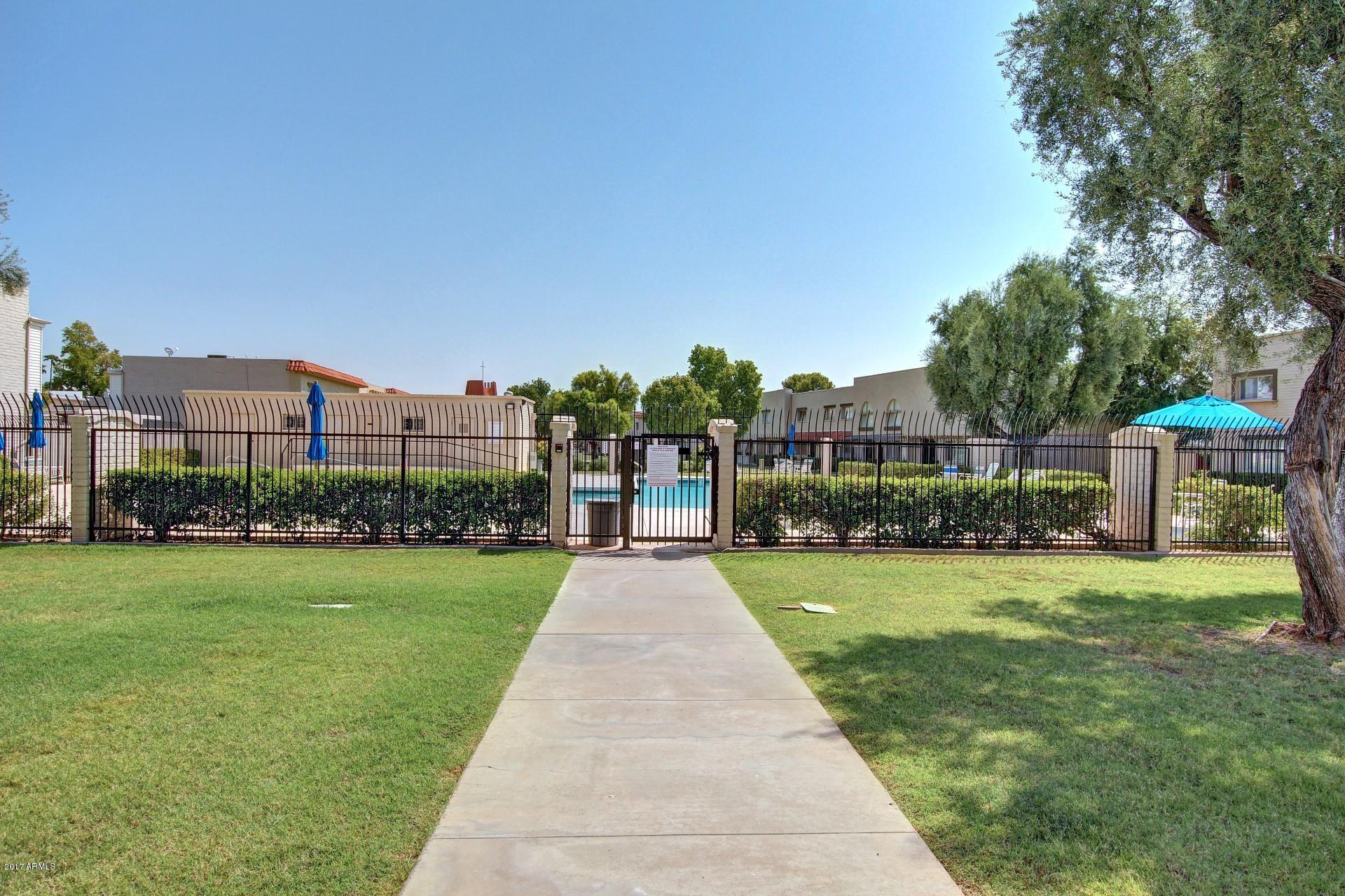 6909 East Osborn Road, Unit F Scottsdale, AZ 85251 - Photo 36 of 55 a front view of a house with yard and green space