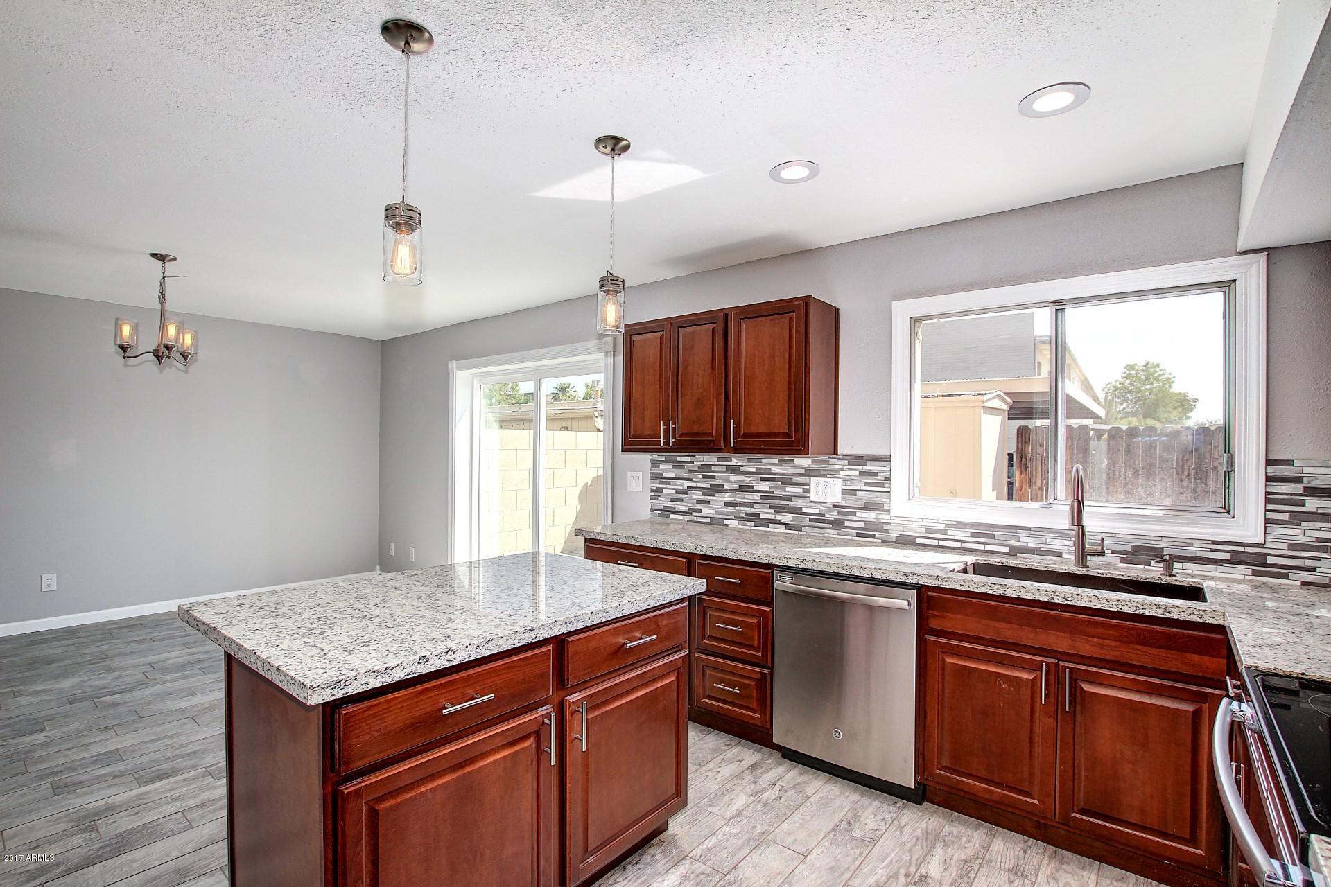 6909 East Osborn Road, Unit F Scottsdale, AZ 85251 - Photo 4 of 55 a kitchen with a stove and a sink