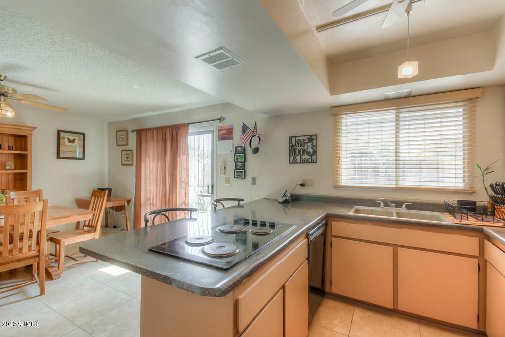 6909 East Osborn Road, Unit F Scottsdale, AZ 85251 - Photo 51 of 55 a kitchen with a sink and cabinets