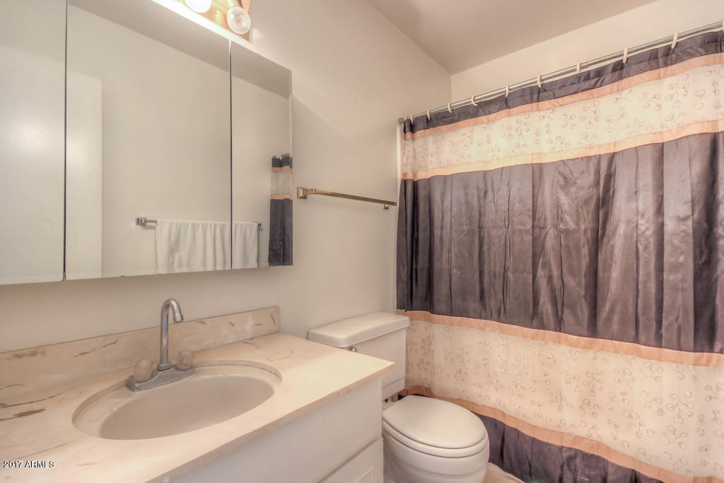 6909 East Osborn Road, Unit F Scottsdale, AZ 85251 - Photo 53 of 55 a bathroom with a sink toilet a mirror and shower