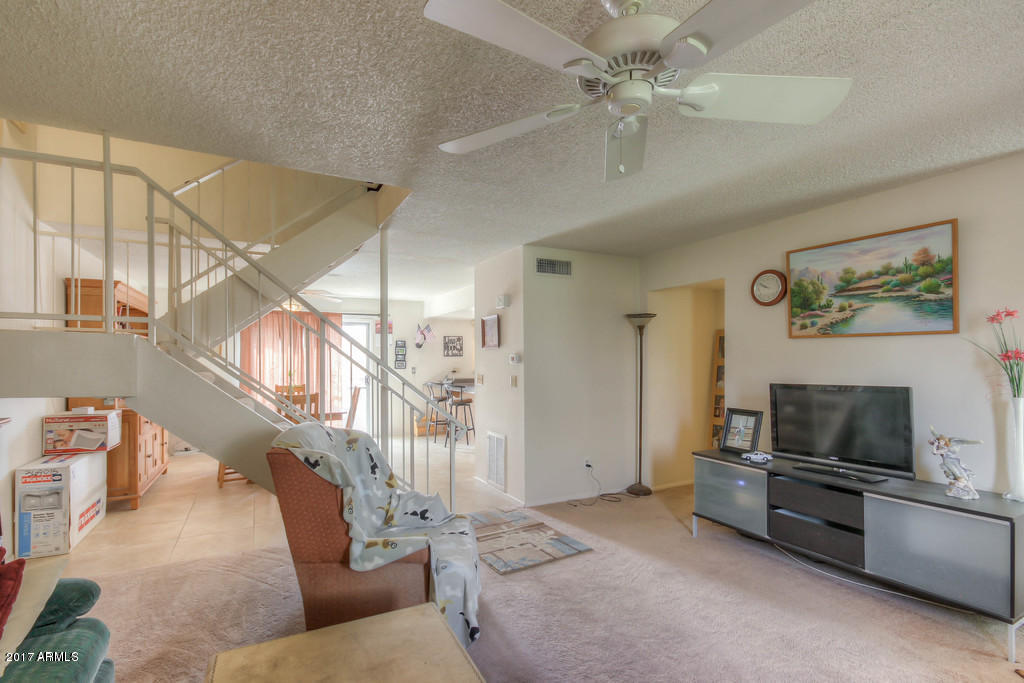 6909 East Osborn Road, Unit F Scottsdale, AZ 85251 - Photo 54 of 55 a living room with furniture and a flat screen tv