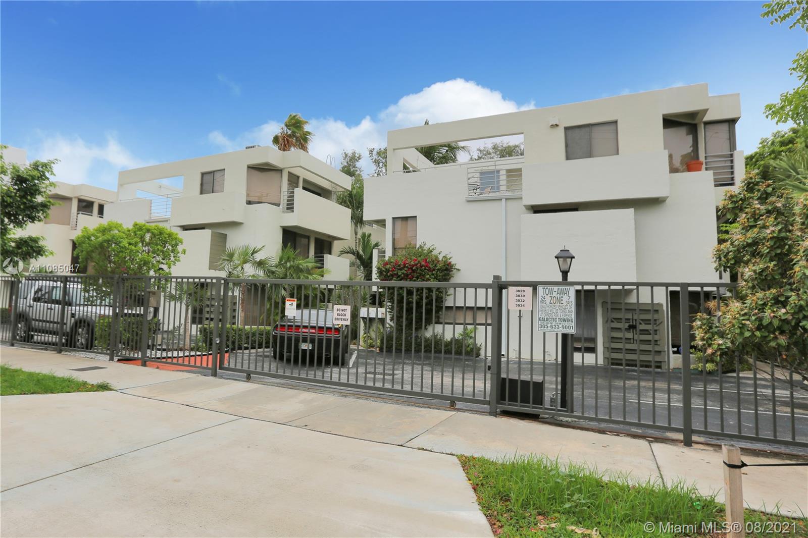3034 Southwest 27th Avenue, Unit 4 Miami, FL 33133 - Photo 1 of 15 a front view of a house with glass windows and fence