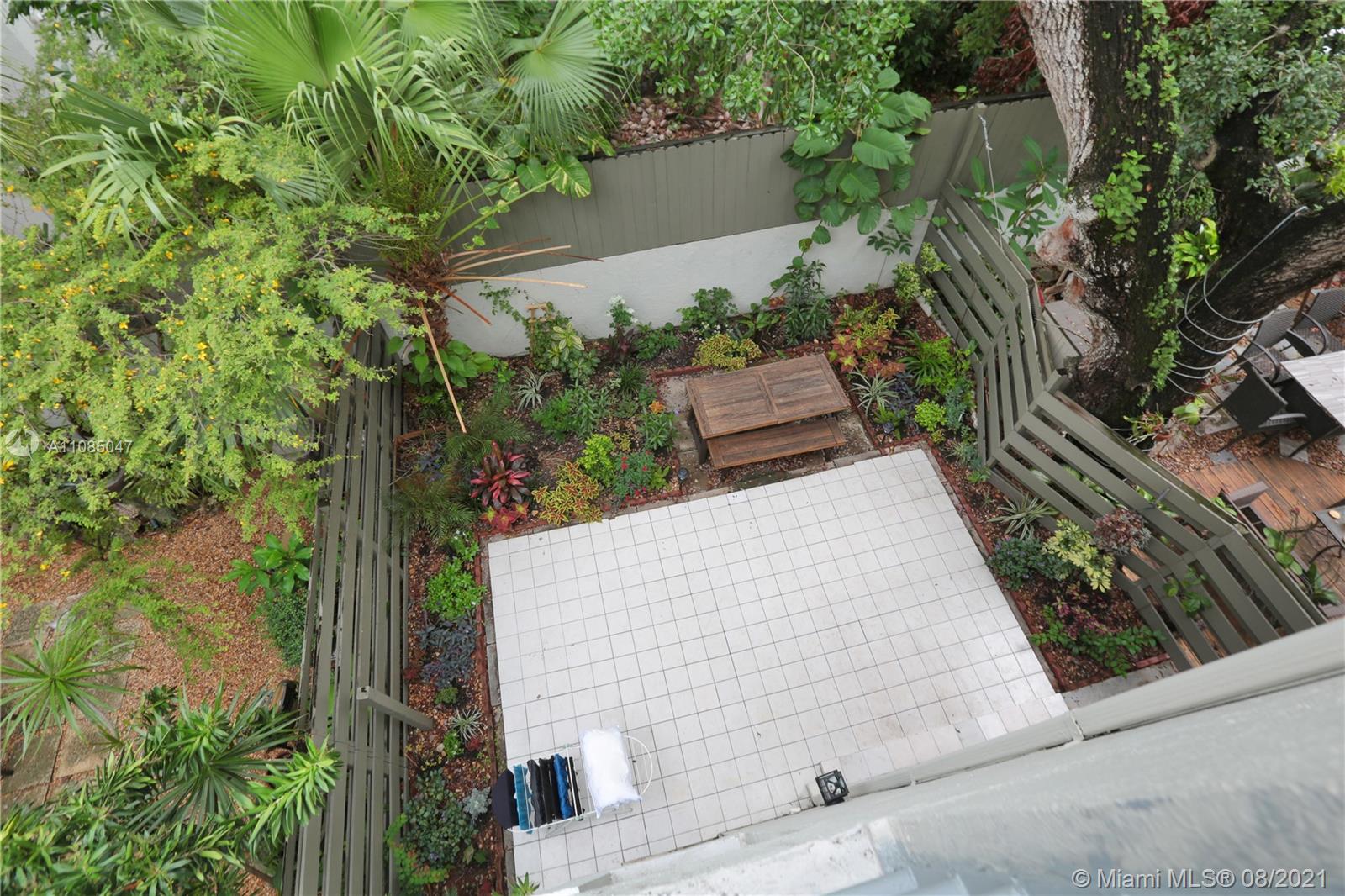 3034 Southwest 27th Avenue, Unit 4 Miami, FL 33133 - Photo 14 of 15 an aerial view of a house with a yard and potted plants