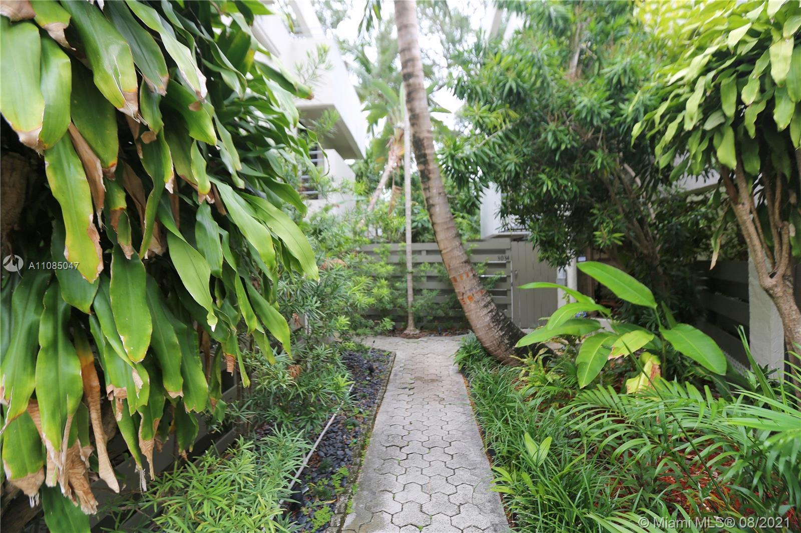 3034 Southwest 27th Avenue, Unit 4 Miami, FL 33133 - Photo 3 of 15 a backyard of a house with lots of green space