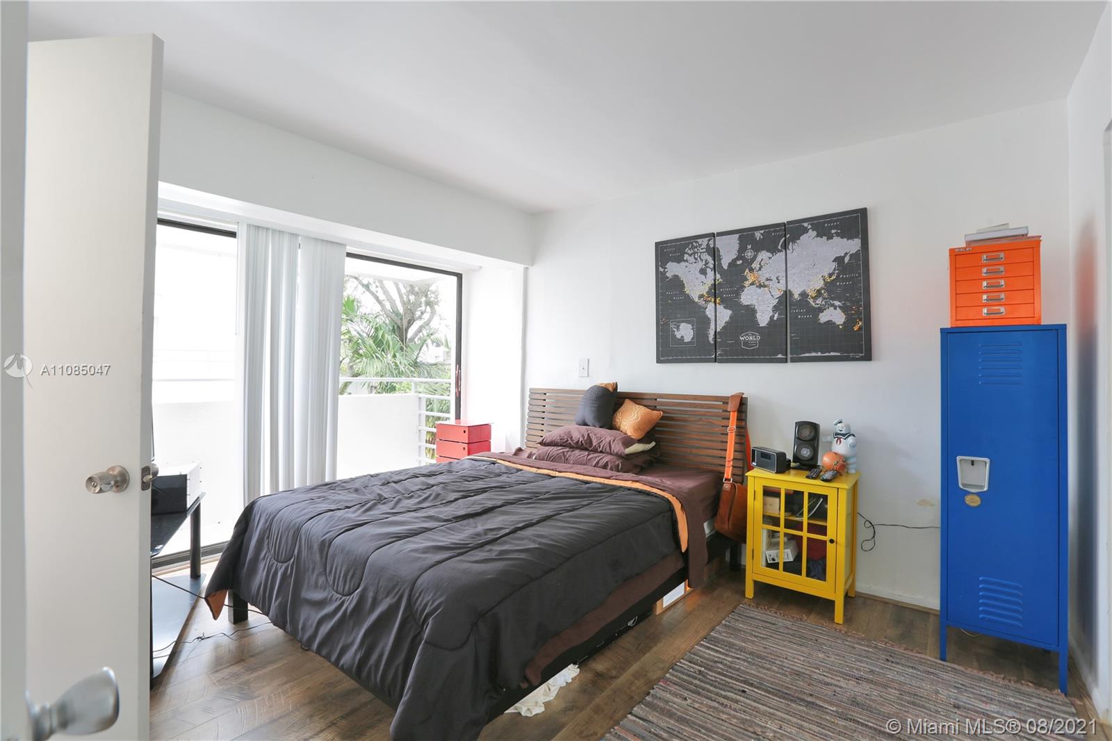 3034 Southwest 27th Avenue, Unit 4 Miami, FL 33133 - Photo 9 of 15 a bedroom with a bed and wooden floor